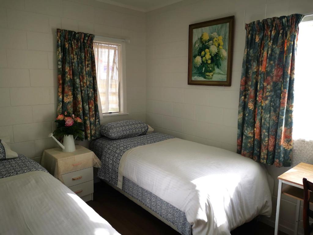 a bedroom with two beds and a window at Nice house on Wesley Auckland in Auckland