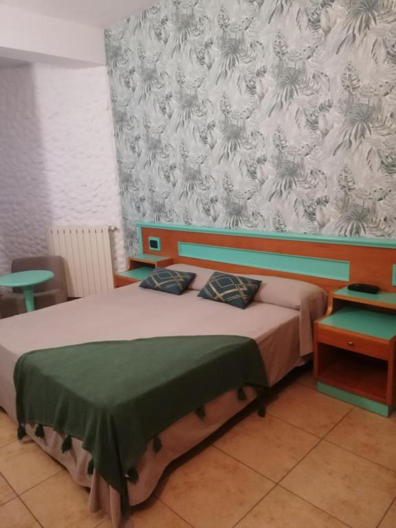 Postel nebo postele na pokoji v ubytování Hotel Esperia