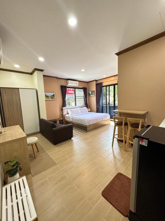 Kata Noi Place في شاطئ كاتا: غرفة معيشة مع سرير وطاولة