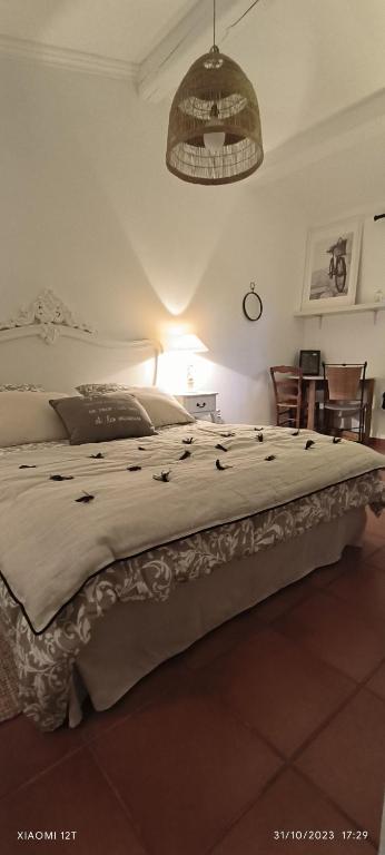 a large bed in a bedroom with a light at Villa féeric in Toulon