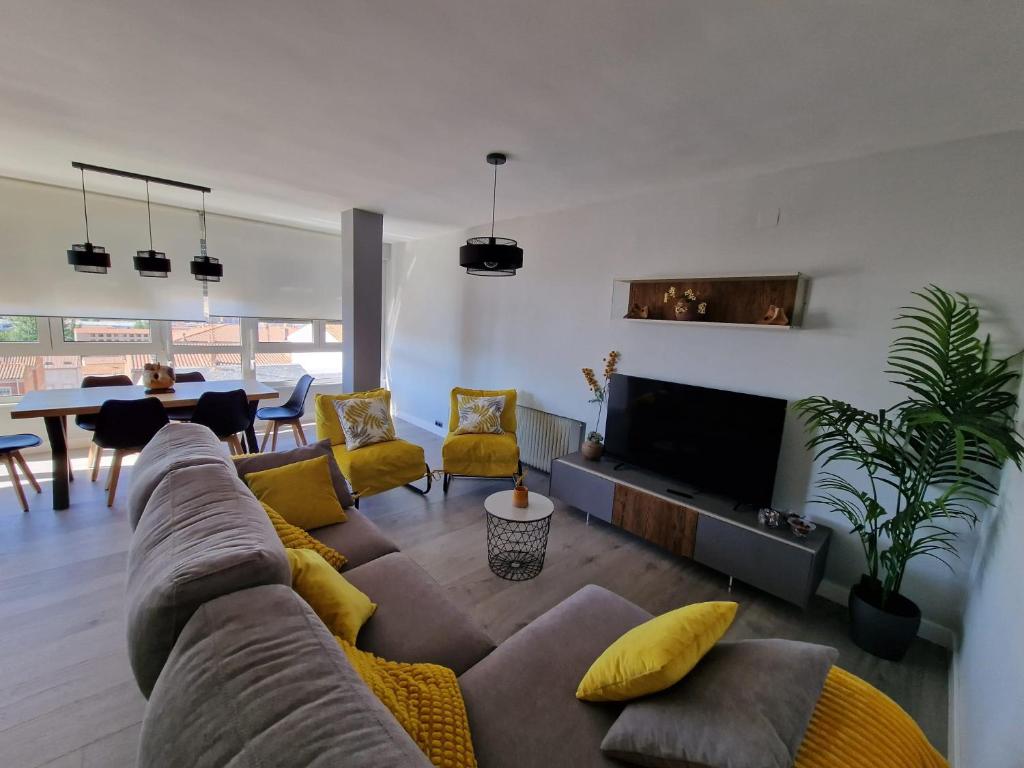a living room with a couch and a dining room at Aurora in Ávila