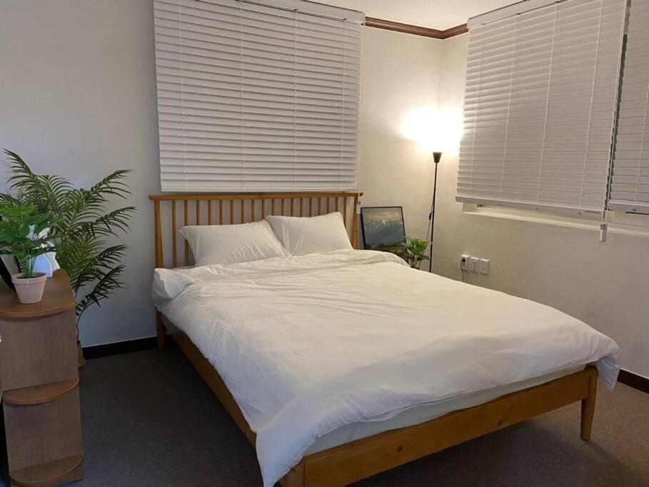 a bedroom with a large bed with white sheets at Maison de Haenggung in Suwon