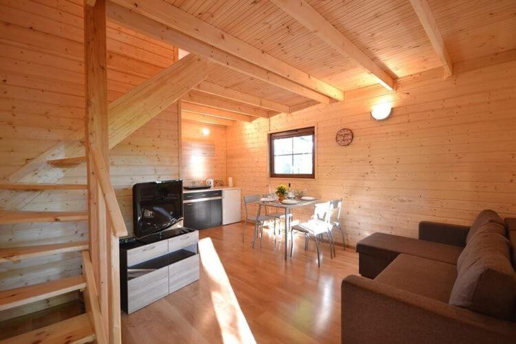 a living room with a couch and a table at Year round holiday house with a terrace near the sea Pustkowo in Pustkowo