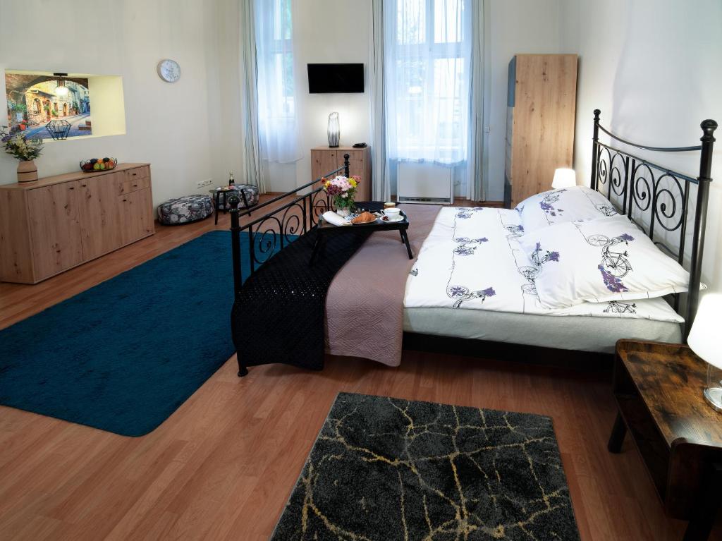 a bedroom with a bed and a blue rug at Czar Prowansji - Comfy & Quiet near Rynek&Train Station in Krakow