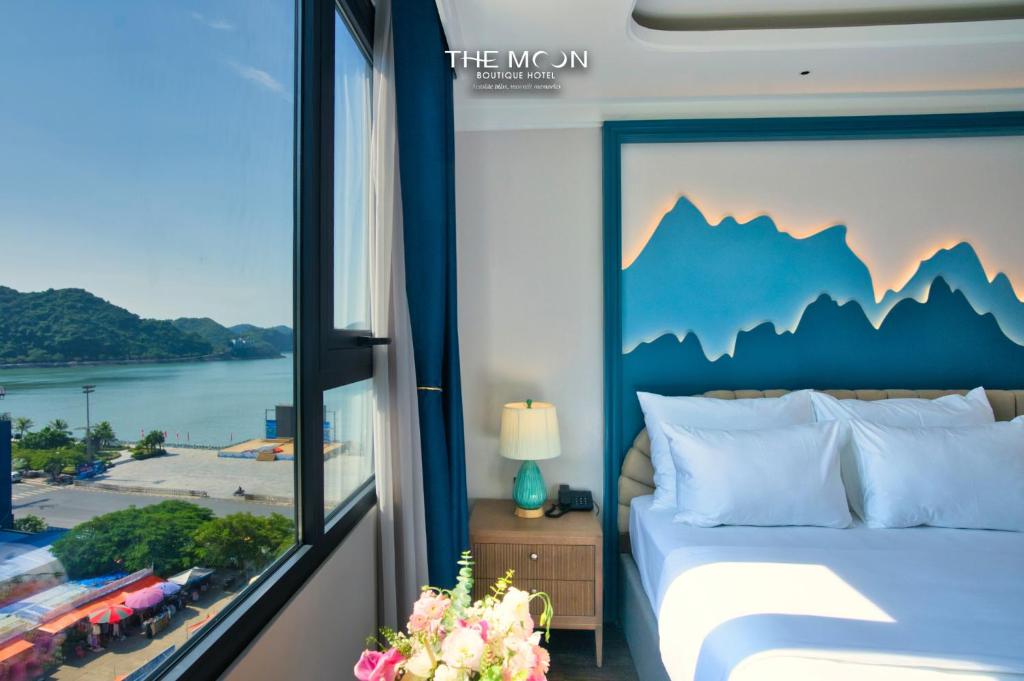 a bedroom with a bed with a view of the mountains at The Moon Boutique Hotel Cat Ba in Cat Ba