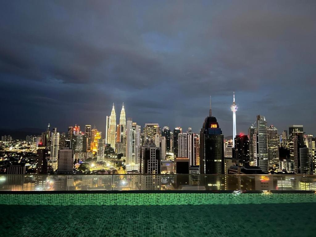 a view of a city skyline at night at Regalia Suite Studio in Kuala Lumpur