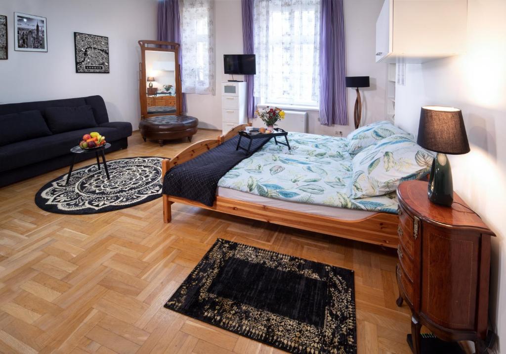 a living room with a bed and a couch at Cozy Apartament Rachel-Near Rynek and train station in Krakow