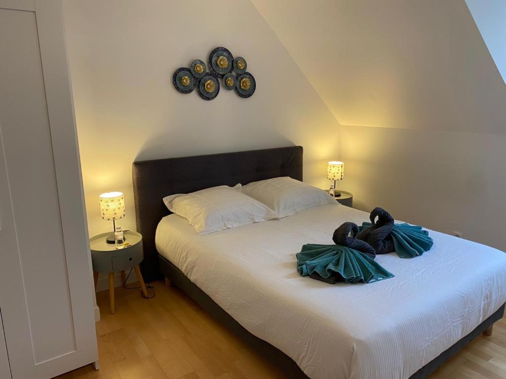 a bedroom with a bed with a teddy bear on it at Le Azzar in Melun