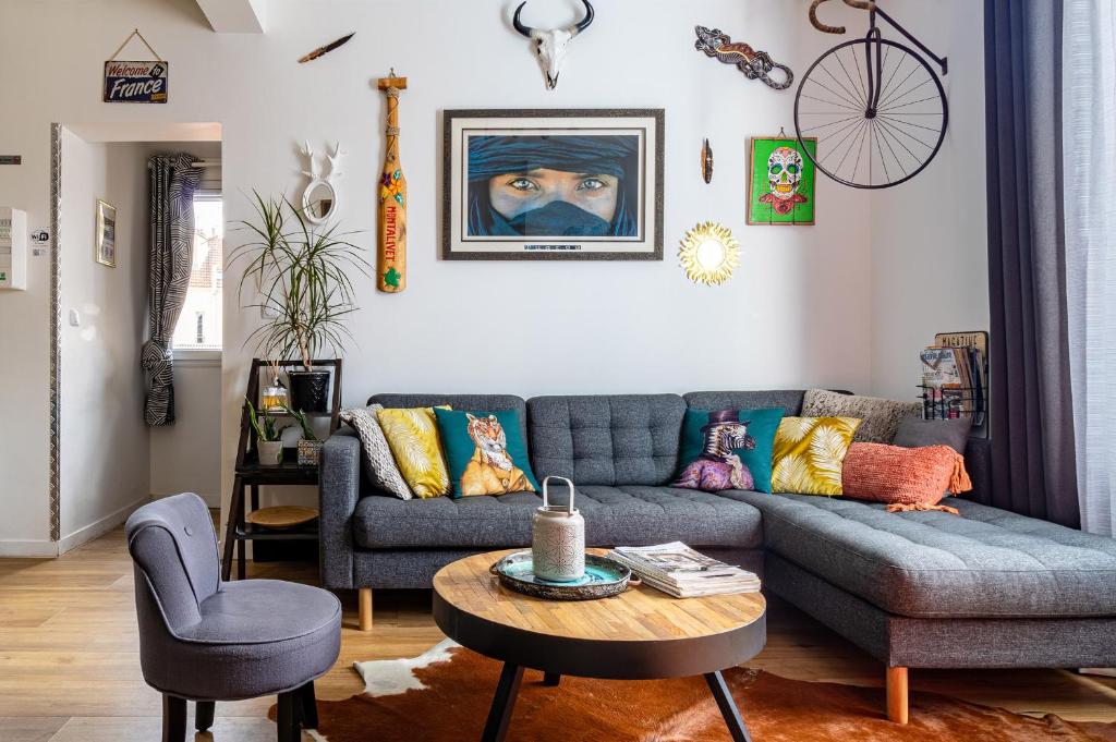 a living room with a couch and a table at Les Fauvelles Paris La Défense in Courbevoie