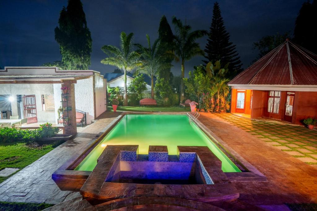 a swimming pool in the backyard of a house at Sprunger Avenue - tulia homes in Moshi