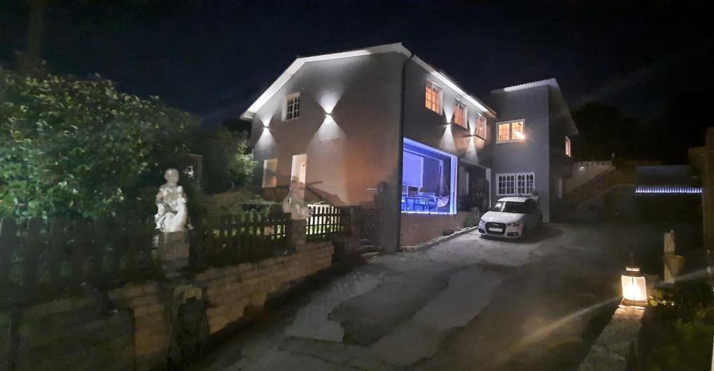 a house with a car parked in front of it at night at Casa Andrea in Valdoviño