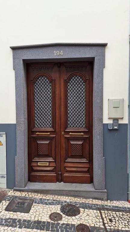 a wooden door on the side of a building at Theo's City House in Funchal