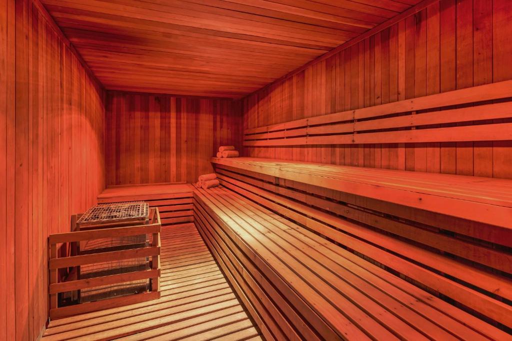 an empty wooden sauna with a bench in it at Grand Fiesta Americana Coral Beach Cancun - All Inclusive in Cancún