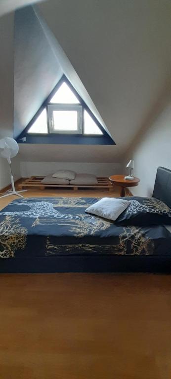 a bedroom with a large bed with a window at KAZ A NINE in Saint-Pierre