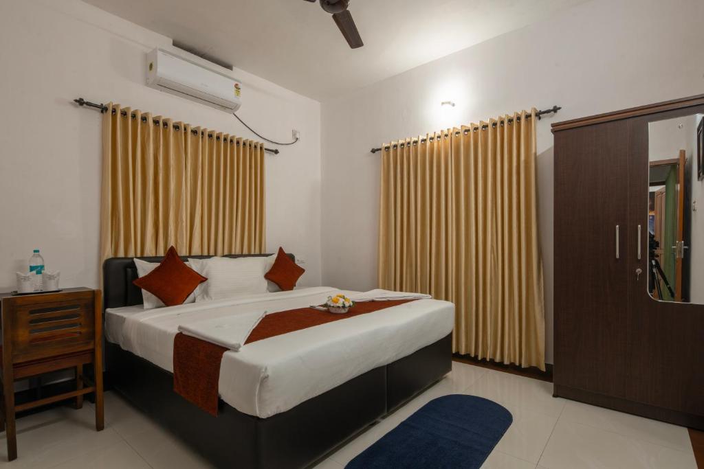 Ένα ή περισσότερα κρεβάτια σε δωμάτιο στο Kochi Vibes Homestay
