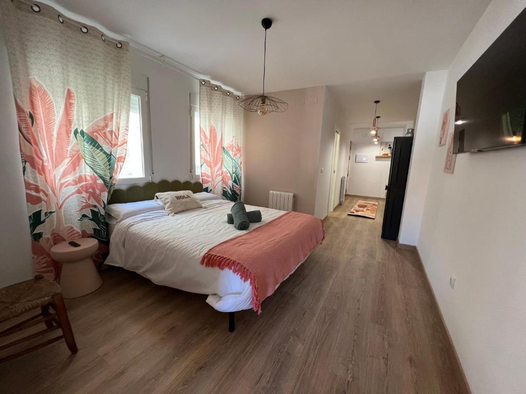 a bedroom with a large bed with a red blanket at Mirador de Lindaraja (vistas a la Alhambra) in Granada