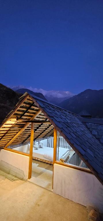 a roof on top of a building with a view at Snow Biscuit Huts in Dharamshala