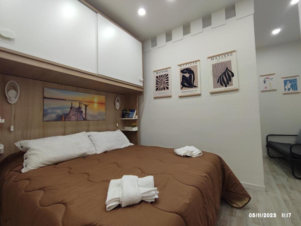 1 dormitorio con 1 cama grande y toallas. en In the Paradise of Gole Alcantara Rooms, en Graniti