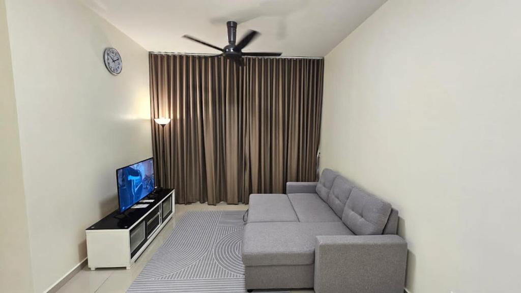 a living room with a couch and a flat screen tv at SYG12 Homestay Dalur Presint 18 in Putrajaya