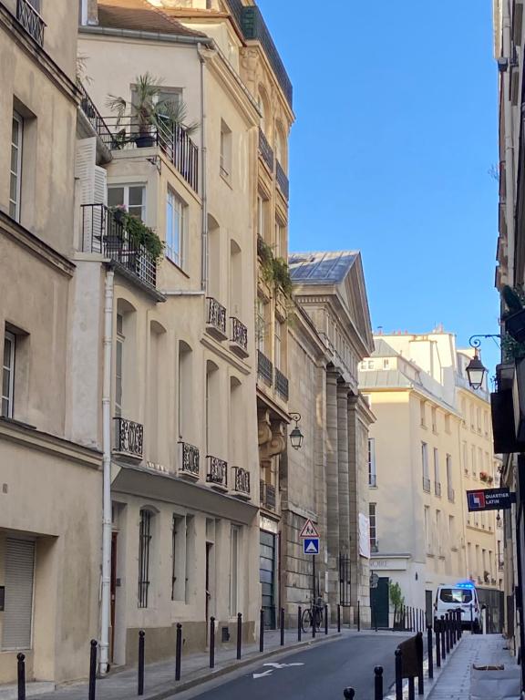 an empty street in a city with buildings at Aux Terrasses de la Lune in Paris