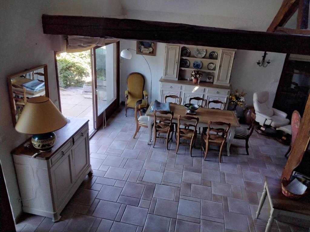 a kitchen and dining room with a table and chairs at le héron cendré in Lans-en-Vercors
