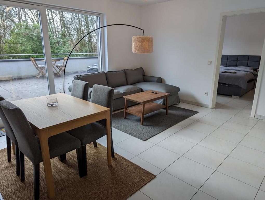 a living room with a couch and a table at 1BR Apartment with Garage in Kirchberg in Luxembourg