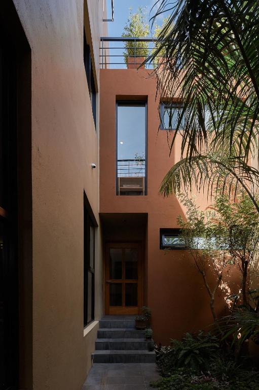a building with stairs leading up to a door at Las Privadas / Casa X By Nardazul in Oaxaca City