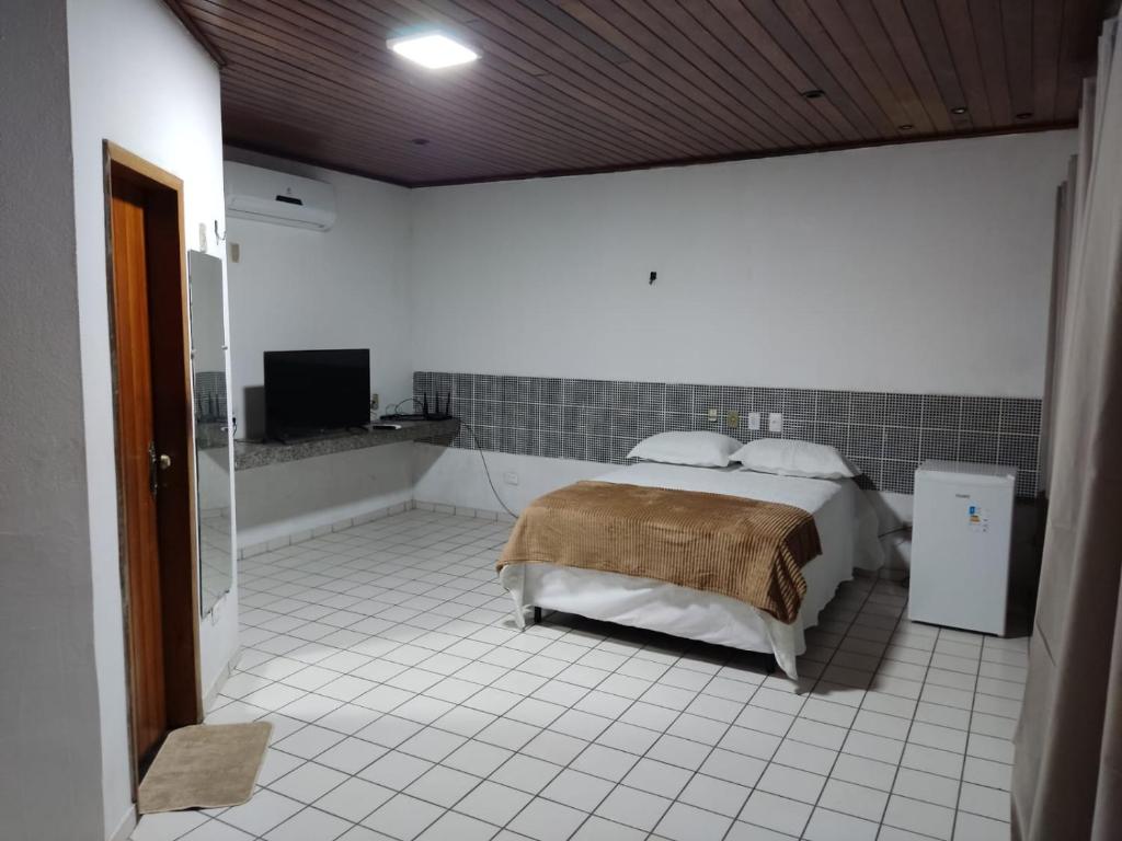 a bedroom with a bed and a tub in a room at AL EVENTOS in Teresina
