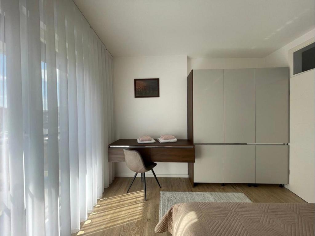 a bedroom with a desk and a chair and a cabinet at AirStay in Pristina