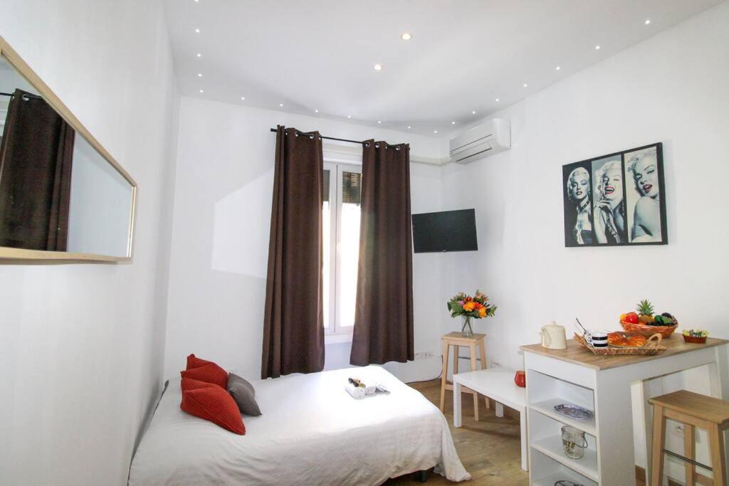 a bedroom with a white bed and a window at Le Borniol By ApiRent #Central #Lumineux #Fonctionnel in Cannes