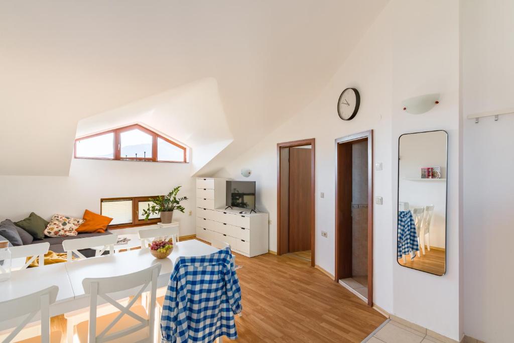 a white living room with a table and a dining room at Todorka Apartments in Bansko in Bansko