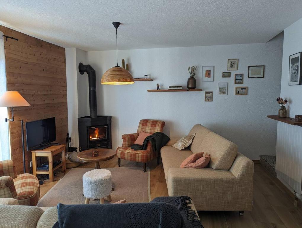 a living room with a couch and a fireplace at Chalet Cactus - 4 Vallées in Hérémence