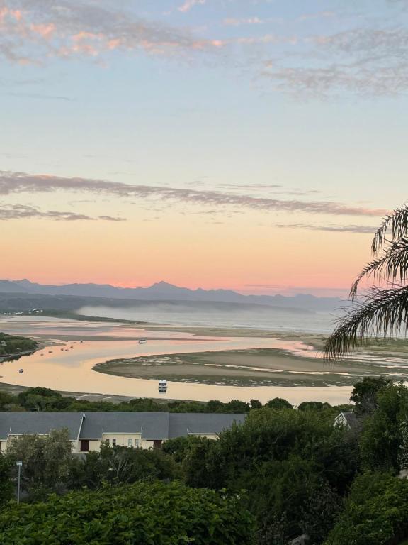 a view of a beach at sunset at Holiday Villa with stunning views near beach. in Plettenberg Bay