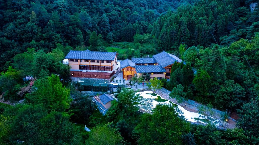 an aerial view of a house in the forest at Wudang Mountain Manju Manor in Wudangshan