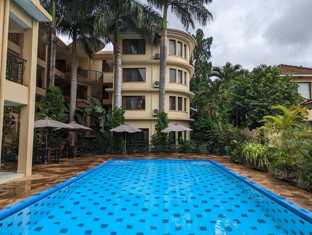 a swimming pool in front of a hotel at Parkview Inn in Moshi