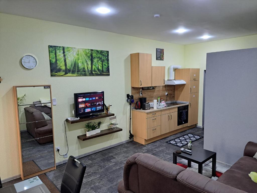 a living room with a couch and a kitchen at Wohnung in Elz in Elz