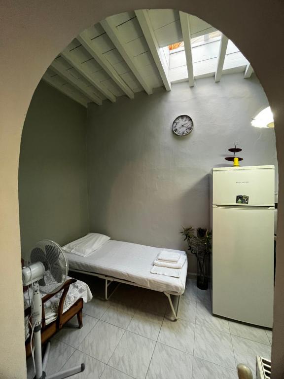 a room with a bed and a clock on the wall at Kioura's home in Ano Syros
