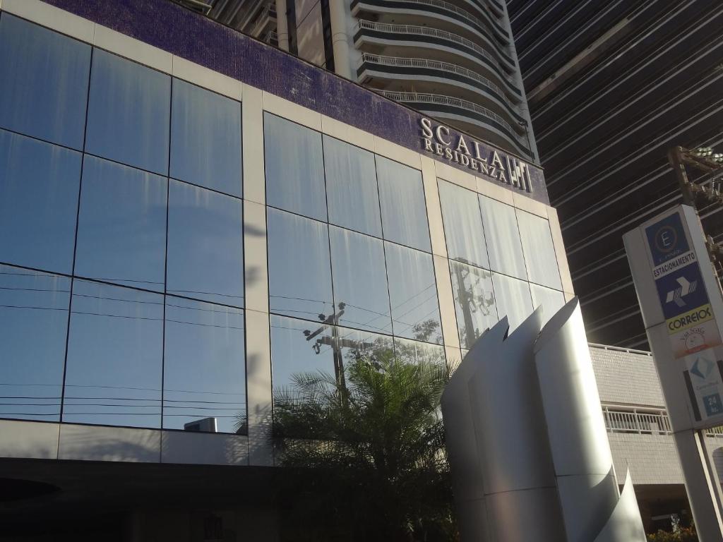 a building with a sign on the side of it at Scala Residence in Fortaleza