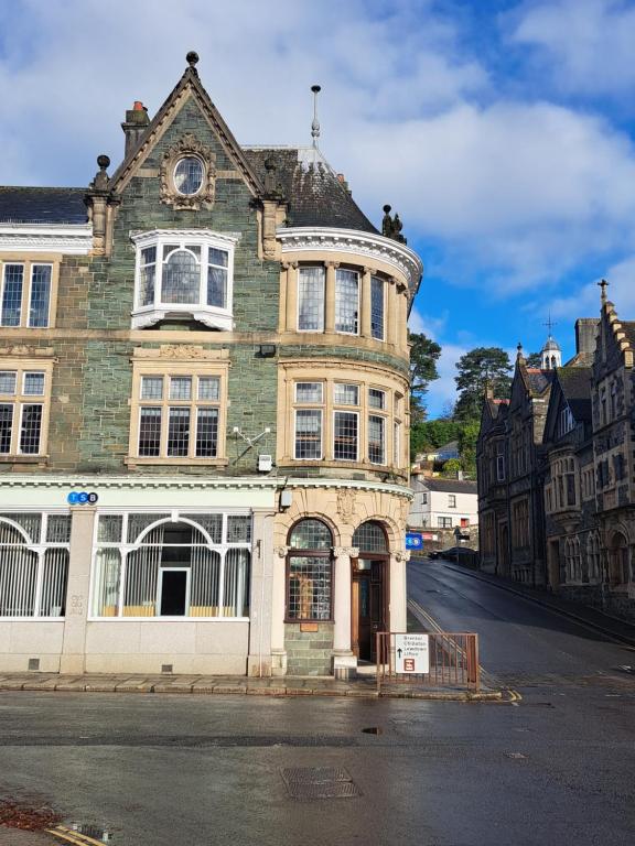 an old building on the corner of a street at Lloyds Penthouse in Tavistock
