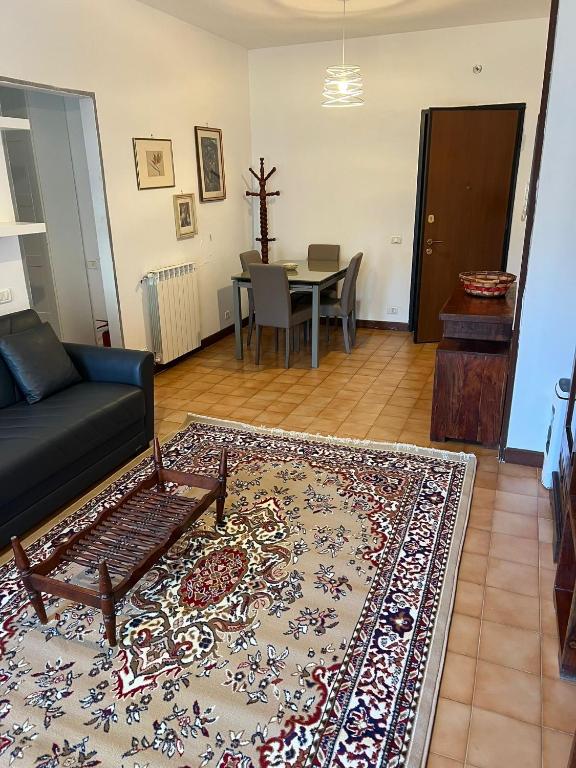 a living room with a couch and a table at Nic holiday house in Santa Marinella