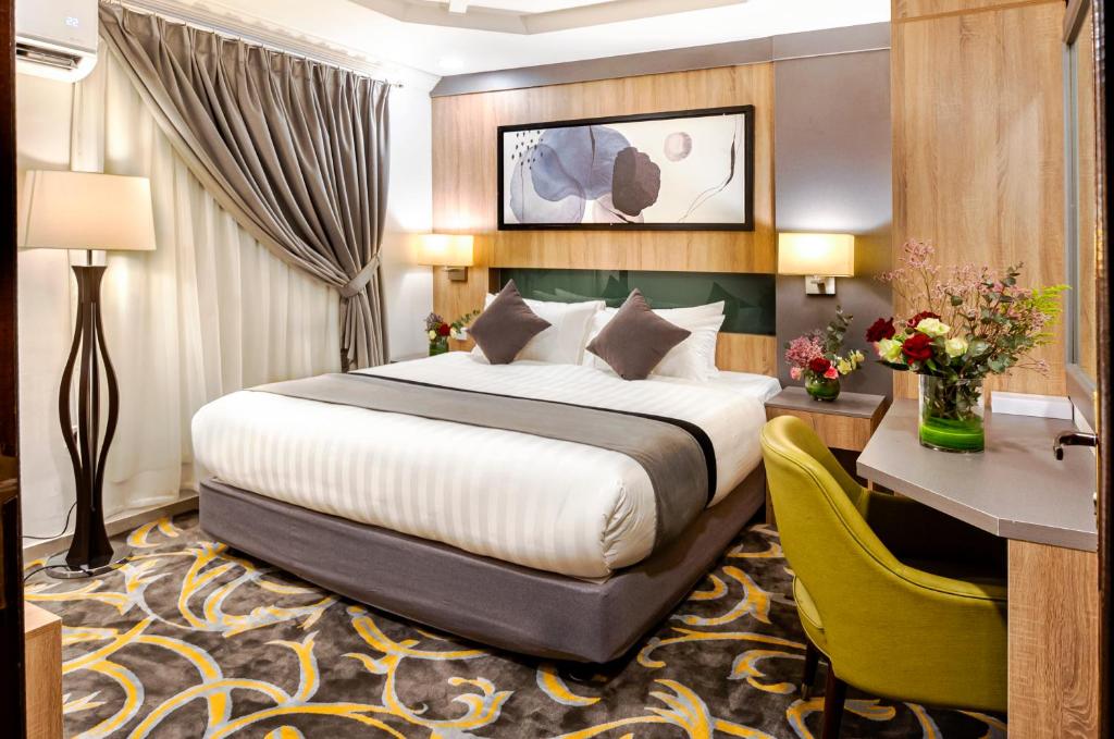Laten Suites Prince Sultan في جدة: غرفة في الفندق مع سرير ومكتب