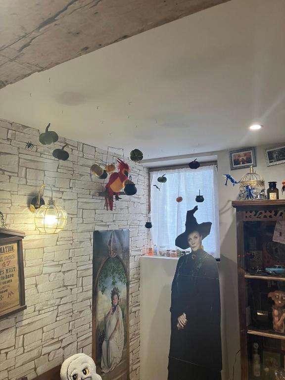 a woman wearing a witch hat standing in a room at Les sorciers, la Diligence St Jean de Losne in Saint-Jean-de-Losne