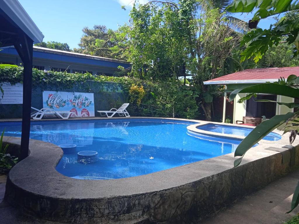 a swimming pool with a rock wall around it at La Casona Eco-Lodge Tortuguero in Tortuguero