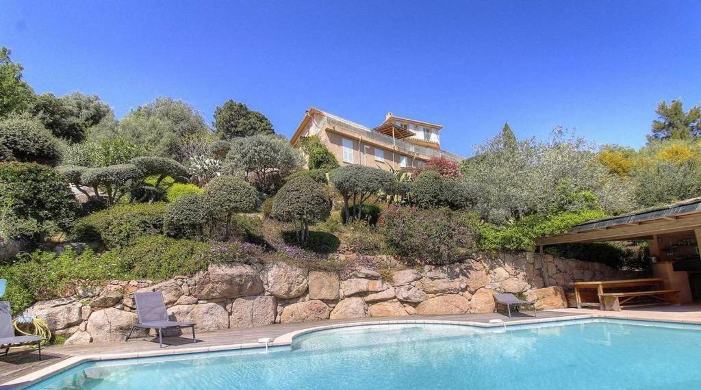 une maison sur une colline avec une piscine dans l'établissement Appartement vue mer en Résidence avec piscine, à Porto-Vecchio