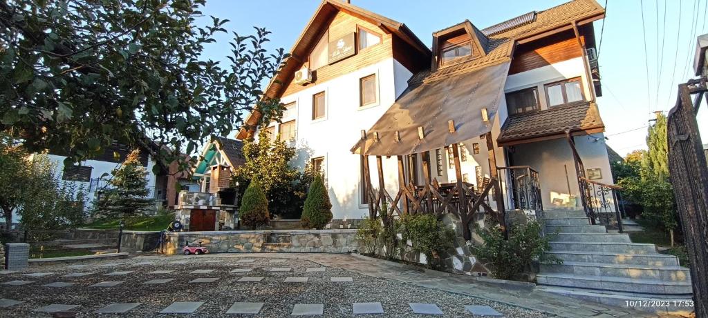 a house with a cobblestone street in front of it at Vila Slanic in Slănic