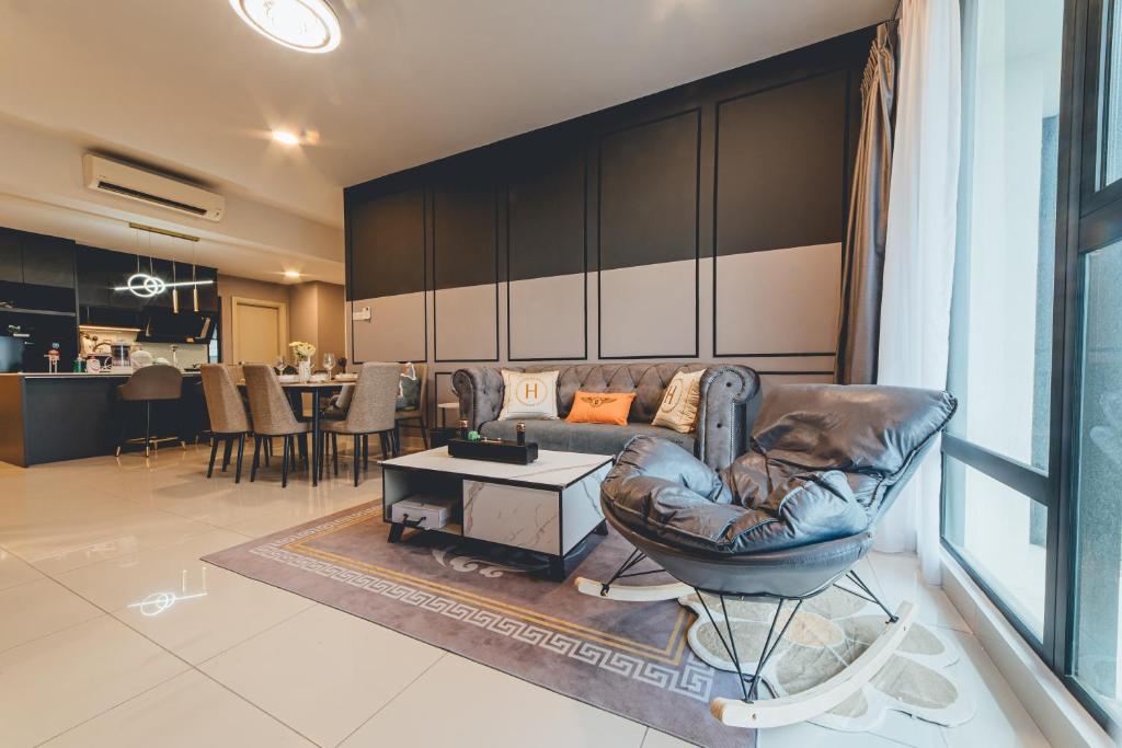a living room with a leather couch and a table at Mosaic Grand Luxury 3BR w bathtub near Midvalley by Our Stay in Johor Bahru
