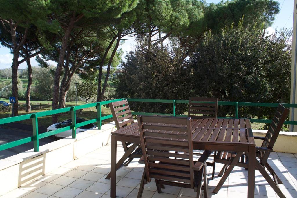 a wooden table and chairs sitting on a patio at Appartamento Stella in Empoli