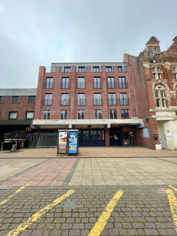 a large brick building in front of a street at A&K Inn in Bournemouth