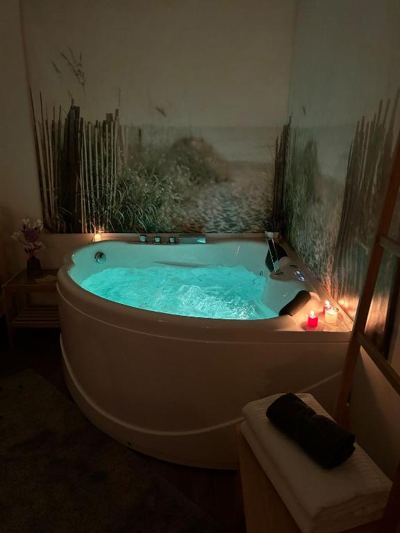 a bathroom with a tub with lights in it at Cottage Cilento B&B in Trentinara