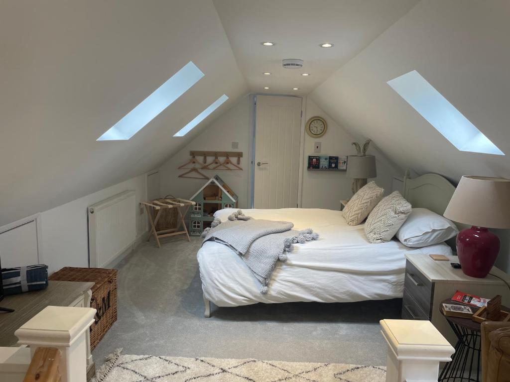 um quarto com uma cama num sótão com clarabóias em Roseberry Loft em Nunthorpe